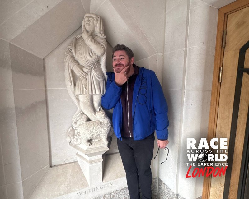 Team posing with Dick Whittington Cat Statue in London