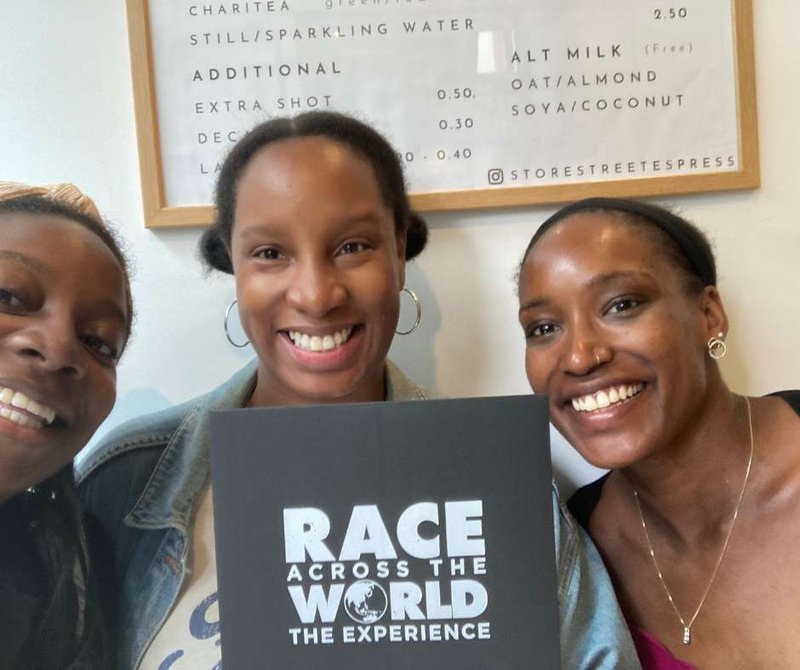 Team posing with the Race Across The World The Experience envelope