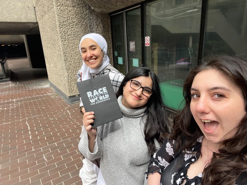 Young adult team playing Race Across The World: The Experience