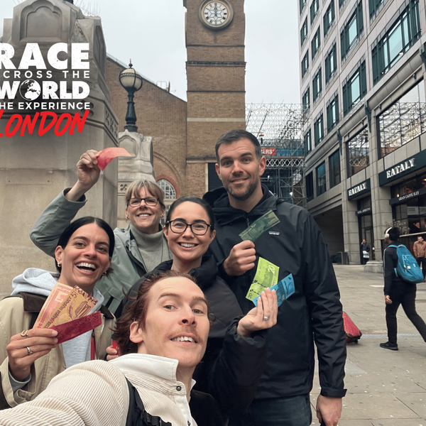 team-posing-with-money-race-across-the-world-experience